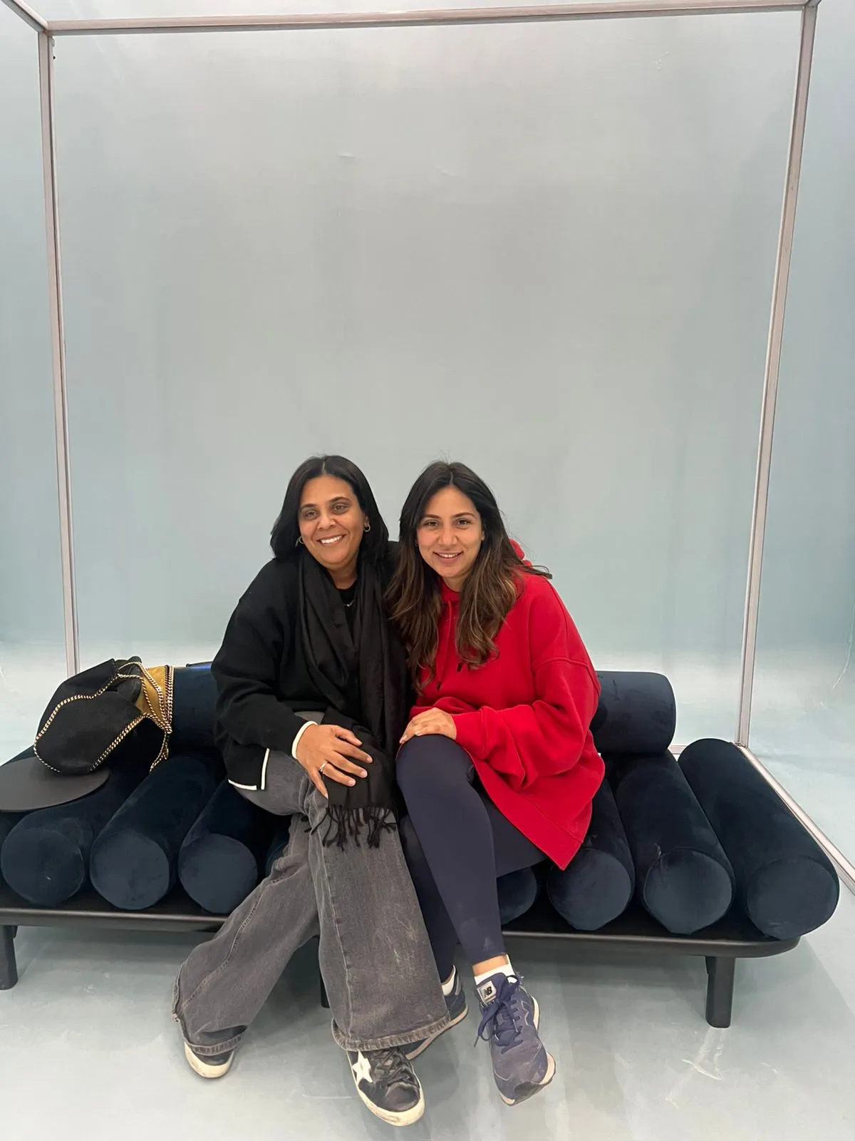 Aurora founders together on a sofa in a studio setting.